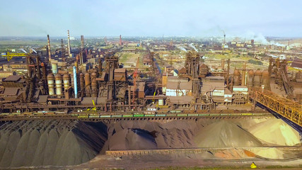 Naklejka premium Aerial view of industrial steel plant. Aerial sleel factory. Flying over smoke steel plant pipes. Environmental pollution. Smoke.