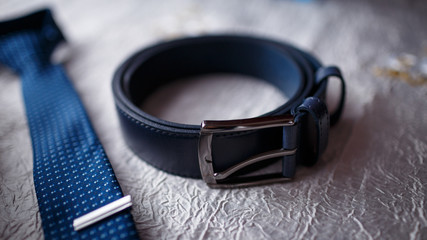 male black belt and blue tie