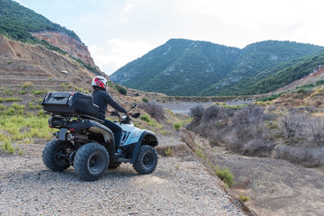 A man is driving ATV on off-road.