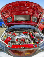 Wide open hood with colorful red parts under the hood