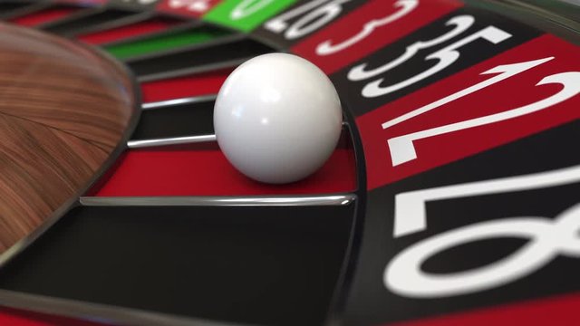 Casino roulette wheel ball hits 12 twelve red