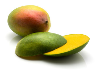 Sliced mango isolated on white background one whole and cut in half.