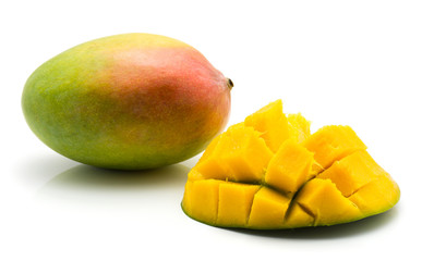 Sliced mango hedgehog shape isolated on white background one half and one whole.