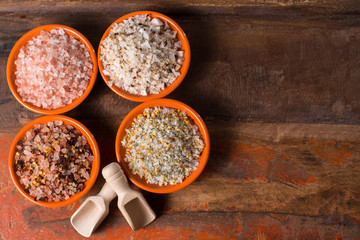 Variety of sea salt, pink Himalayan salt, colorful salt with dried chili pepper, herbs and spices. Top view. Copy space.