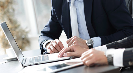 close-up.businessman working with laptop at his Desk.