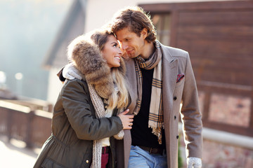 Happy couple walking outdoors in winter
