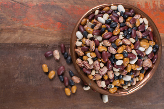 Variety of protein rich colorful raw dried beans copy space
