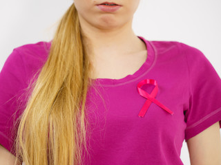 Woman having pink breast cancer ribbon on tshirt
