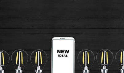 new ideas. telephone on the table and light bulbs. background for ideas - 181538991