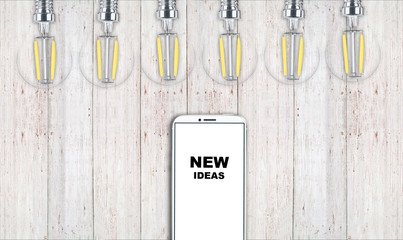 new ideas. telephone on the table and light bulbs. background for ideas - 181539149