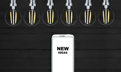 new ideas. telephone on the table and light bulbs. background for ideas - 181539171