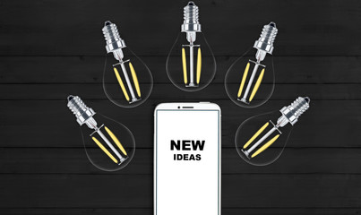 new ideas. telephone on the table and light bulbs. background for ideas - 181539177