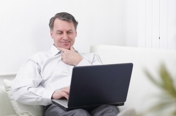businessman with laptop works in the room
