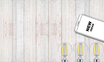 new ideas. telephone on the table and light bulbs. background for ideas - 181539393