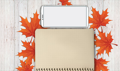 notebook, phone are lying on a wooden table with yellow, autumn leaves - 181540306