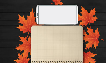 notebook, phone are lying on a wooden table with yellow, autumn leaves - 181540348