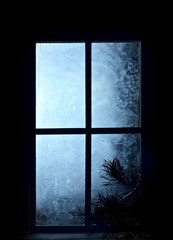 Frosted window .Christmas greeting card.Athmosperic photography.Closeup.Winter.Frost.Indoor shot