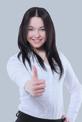 Successful business  woman posing against gray background.