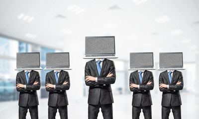 Businessmen with laptops instead of head.