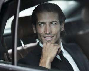 closeup.successful businessman sitting in the car