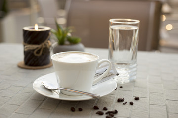 Coffee cream milk in bar romantic candle close top view beans