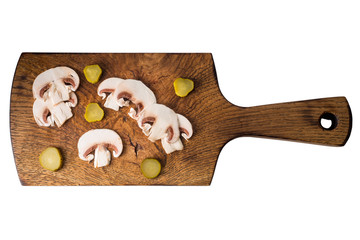 Sliced champignon mushrooms on wooden board