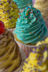 Colorful cupcakes on a pink background