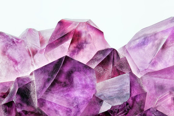 Crystal Stone macro mineral, purple rough amethyst quartz crystals on white background