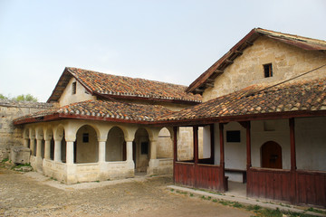Fototapeta premium Ancient cave town/city of Crimean Tatar - Chufut-Kale, Mangup-Kale, Bakhchisaray. Historical ruins and amazing place. The Caves was built in the limestone walls. Cultural Landscape.