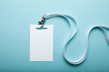 Empty plain name tag mock up, on blue background. Business blank badge.