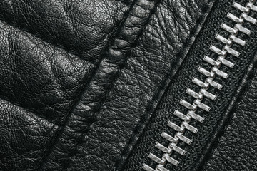 Black leather fabric stitched jakcket metal zipper background.