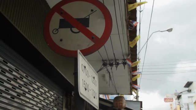 Street sign forbidden passing food cart. Pictogram with banning fastfood moving carts. Bangkok street, Thailand.