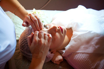 Obraz na płótnie Canvas spa salon face massage. Close-up of a young woman getting spa treatment at beauty salon. spa face massage. facial beauty treatment.