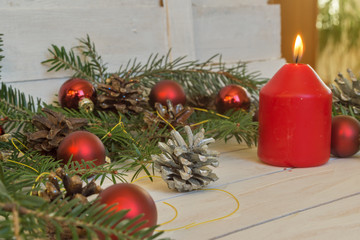 Christmas decoration with fir branches, cones and toys on white wooden background