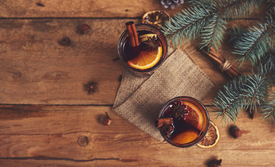 Christmas hot mulled wine with cinnamon cardamom and anise on wooden background