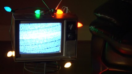 Static on television covered in holiday lights