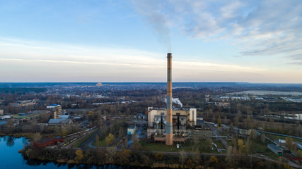 Obraz premium Garbage incineration plant. Waste incinerator plant with smoking smokestack. The problem of environmental pollution by factories.