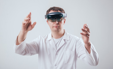 Doctor uses augmented reality goggles.