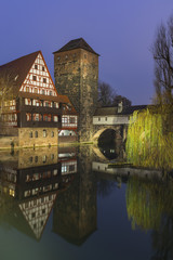 Germany, Bavaria, Nuremberg. The famous Henkerhaus with refrecions in the river.