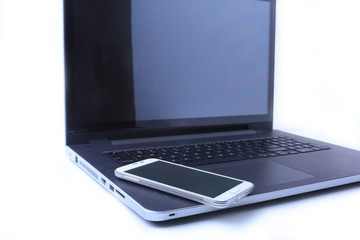 Office workplace with laptop, smart phone on table