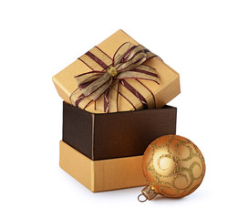 Golden classic gift box with brown bow and Christmas tree ball