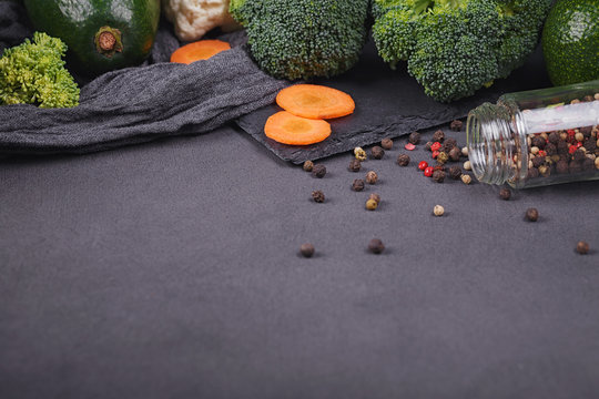 Fresh organic vegetables on dark background. Vegetarian food table ingredients.
