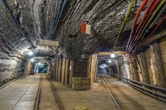Two illuminated underground tunnels in old mine