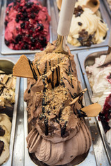Creamy italian ice-cream in shop window, displayed in metal tubes. Ice cream parlor 