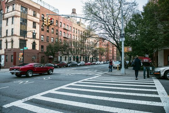 Manhattan uptown intersection with light, cars and crosswalk