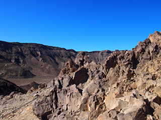 the volcanic landscape of teide national park in tenerife with rugged rocks and caldera rim