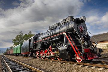 Retro Soviet locomotive with a red star at the station. Transport © DmyTo