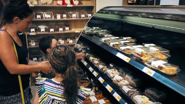 Young family in a french supermarket buying cakes and pastries
