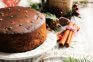 Homemade Traditional Christmas cake on festive rustic white wood, seective focus