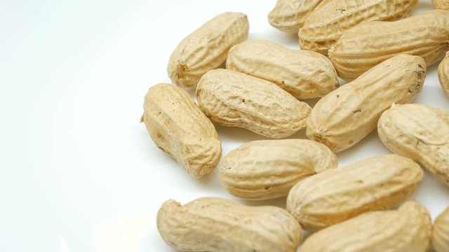 4k, Close-up studio shot footage of peanuts rotates in left side